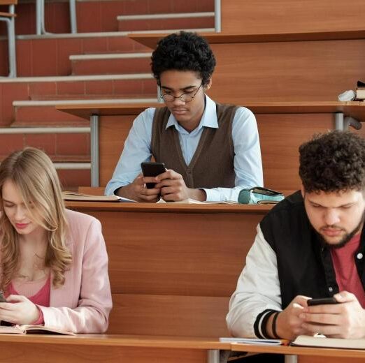 group-contemporary-young-intercultural-students-casualwear-sitting-by-desks-lecture-hall-scrolling-smartphones-break (2) (1) (1)
